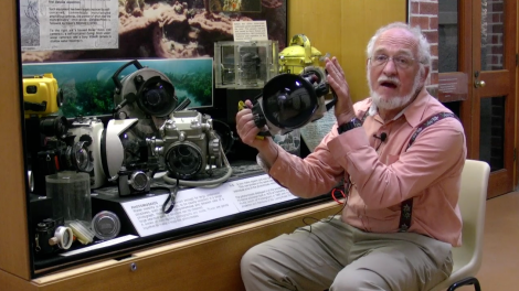 Patrick Baker standing at a photography exhibition